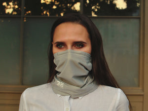 A woman wearing a Three Elements Air Filtering Scarf.