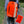 Charger l&#39;image dans la galerie, A woman wearing a CYCL high visibility backpack cover rides a bike.
